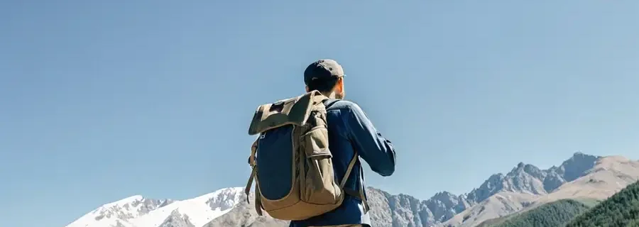 male-traveler-in-kyrgyzstan-stands-with-his-back